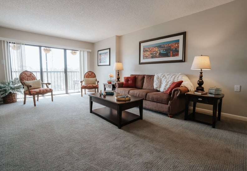Furnished Living Room with Balcony View at Independent Living Facility