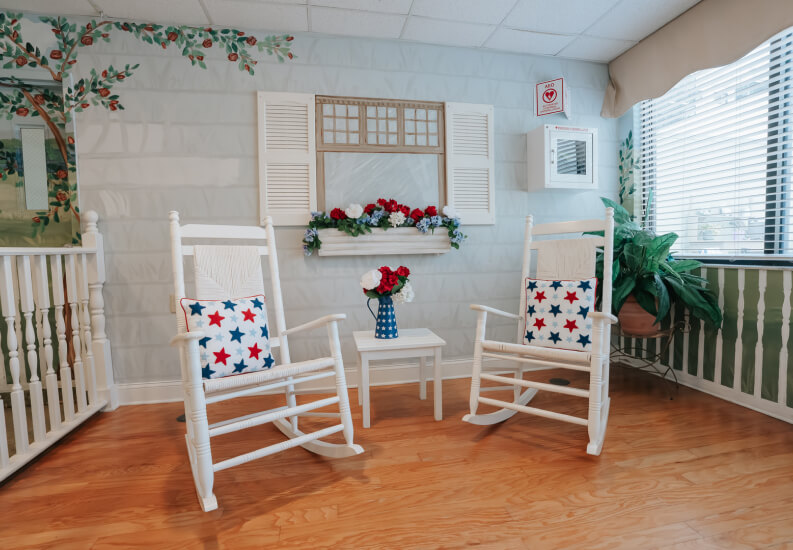 Comfortable Rocking Chair Seating Area with Decorative Window at Memory Care Facility Comfortable Rocking Chair Seating Area with Decorative Window at Memory Care Facility