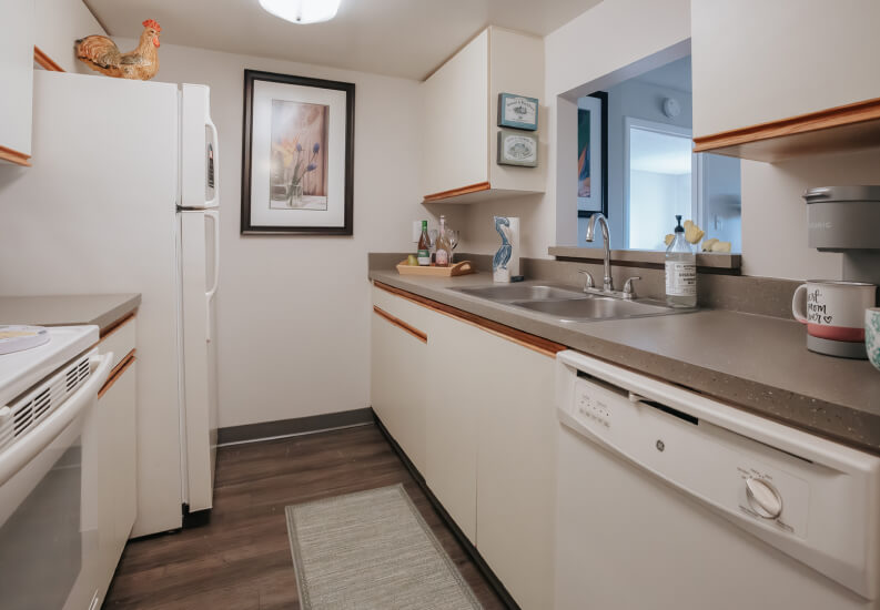 Modern Kitchen with White Cabinets at Independent Living Facility Modern Kitchen with White Cabinets at Independent Living Facility