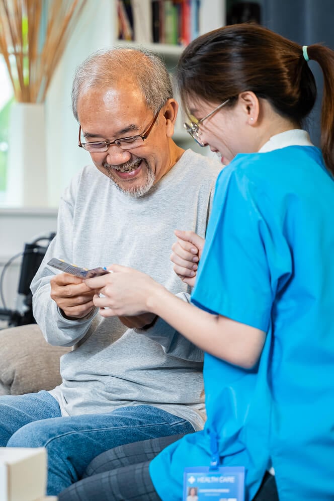 Nurse Comforting Elderly Woman at Nursing Home Oxford
